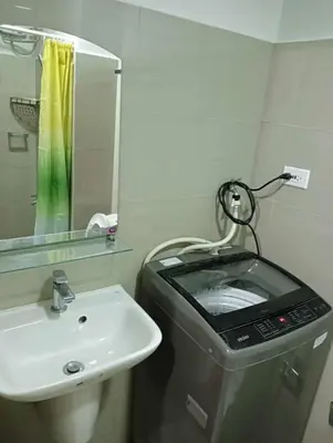 a bathroom with a sink and a washing machine at la Chicka - 295 T3 in Manila