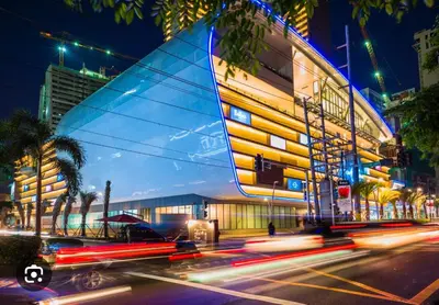 a building with a sail on the side of a street at 42nd Floor 2BR with Stunning Views & 7 Pools in Manila