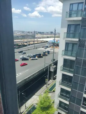 a view of a city street with a highway at 1 Bedroom Near Airport by Rqui in Manila