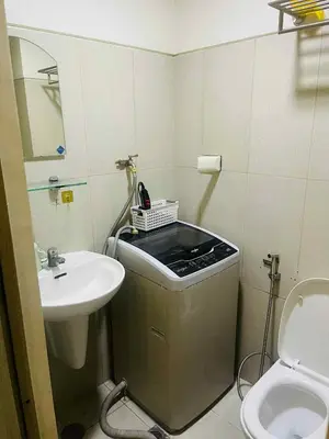 a small bathroom with a sink and a toilet at Breeze Residences in Manila