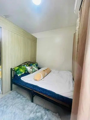 a small bedroom with a bed in a room at Breeze Residences in Manila