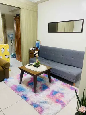 a living room with a couch and a coffee table at Breeze Residences in Manila