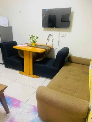 a living room with a table and a couch at Breeze Residences in Manila