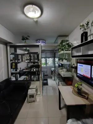 a living room with a couch and a table at SM MOA staycation condotel in Manila