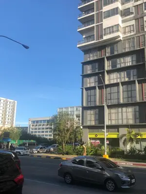 a car parked in front of a tall building at SM MOA staycation condotel in Manila