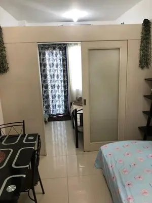 a room with a door leading to a bedroom at SM MOA staycation condotel in Manila