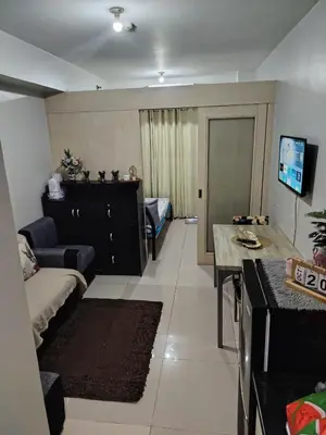 a living room with a couch and a table at SM MOA staycation condotel in Manila