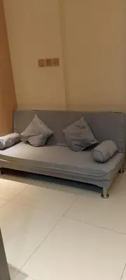 a couch in a room with pillows on it at Shell Residence in Manila