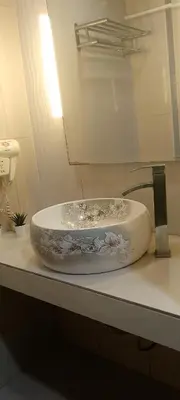 a sink in a bathroom with a mirror at Shell Residence in Manila