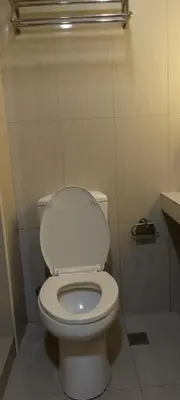 a bathroom with a white toilet in a stall at Shell Residence in Manila