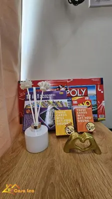 a table with a box of candy and a vase with flowers at Cozy Staycation in Mandaluyong in Manila