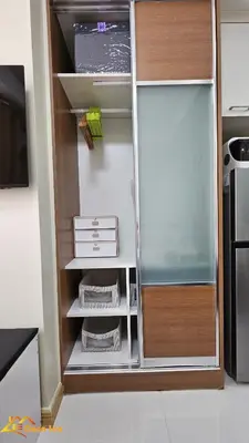 a refrigerator with its door open in a kitchen at Cozy Staycation in Mandaluyong in Manila