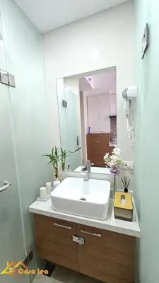 a bathroom with a sink and a large mirror at Cozy Staycation in Mandaluyong in Manila