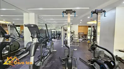 a gym with treadmills and elliptical machines at Cozy Staycation in Mandaluyong in Manila