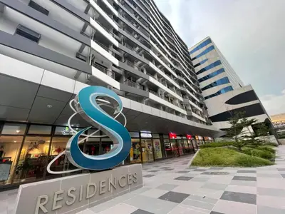 a building with a s sign in front of it at Sojourn in S Residences in Manila