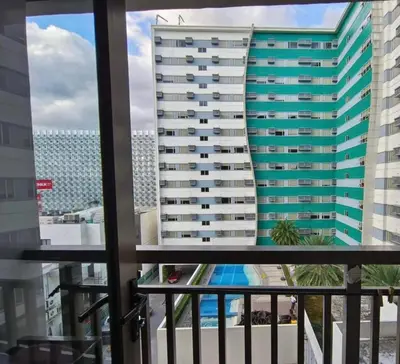 a view of a tall building from a balcony at Sojourn in S Residences in Manila