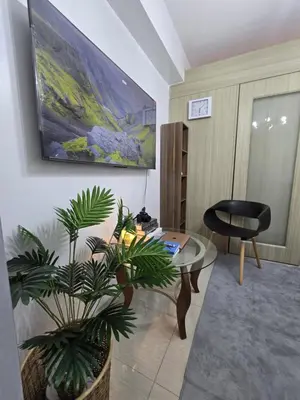a living room with a table and a chair at Gracie's Suites by Staycation With FREE Parking in Manila