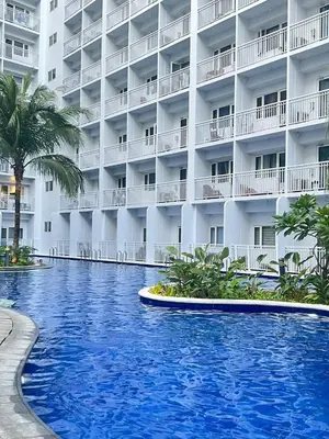 a swimming pool in front of a hotel at Gracie's Suites by Staycation With FREE Parking in Manila