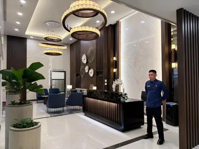 a man standing in the lobby of a hotel at Luxurious Modern Cozy Manila Bayview Pool View 1 2 3 Bedrooms Near Manila Airports Okada Solaire MOA in Manila