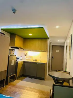 a kitchen with a table and a green ceiling at Folks Hub in Manila