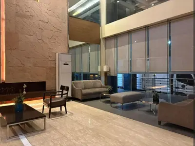 a lobby with couches and chairs and a table at Folks Hub in Manila
