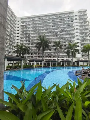 a large apartment building with a large swimming pool at Moa shell residence pasay city in Manila