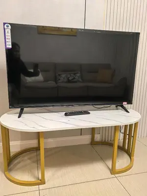 a flat screen tv sitting on top of a table at Shell Residence Moa in Manila