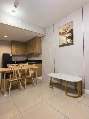 a kitchen with a table and two chairs and a table at Shell Residence Moa in Manila