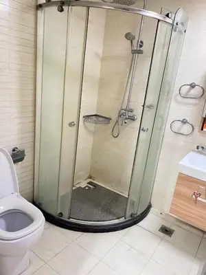 a bathroom with a shower and a toilet at R&R Entire Rental Unit in Manila