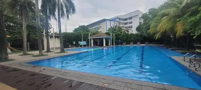 a large blue swimming pool with a gazebo at JACC Condotel in Manila