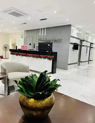 a living room with a plant on a table at JACC Condotel in Manila