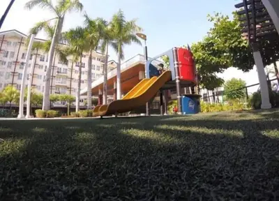 a child on a slide at a playground at JACC Condotel in Manila
