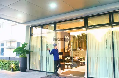 a man standing in front of a store window at iWandr Suites at SMDC Charm Residences in Manila