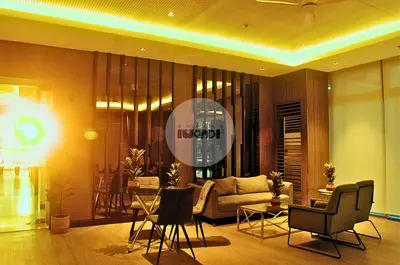 a living room with a couch and a table and chairs at iWandr Suites at SMDC Charm Residences in Manila