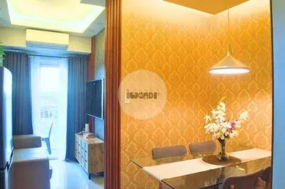 a room with a table with a vase of flowers on the wall at iWandr Suites at SMDC Charm Residences in Manila