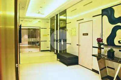 a lobby with a staircase and a glass door at iWandr Suites at SMDC Charm Residences in Manila
