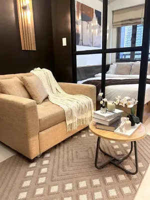 a living room with a couch and a table at The Makati Suites at Red Residences, Premium Studio, City View, Makati CBD, Wi-fi in Manila