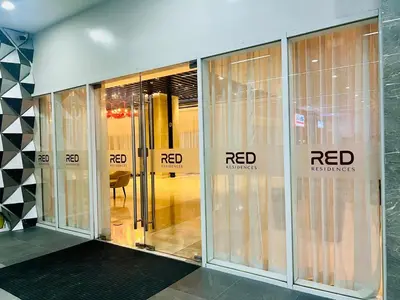 an entrance to a building with revolving glass doors at The Makati Suites at Red Residences, Premium Studio, City View, Makati CBD, Wi-fi in Manila