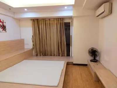 a living room with a large white rug on the floor at R&R Empire Rental Unit in Manila