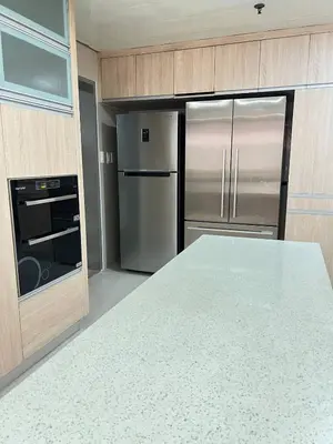 a kitchen with a stainless steel refrigerator and cabinets at R&R Empire Rental Unit in Manila