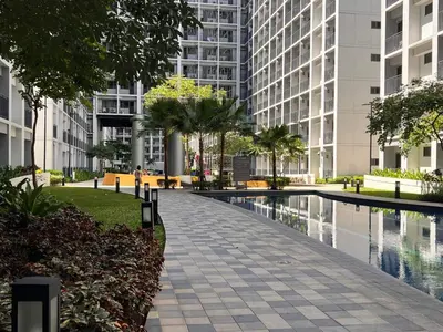 a walkway in front of a large building at Win-Ter Staycation 1 in Manila