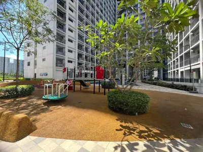 a playground in front of a tall building at Win-Ter Staycation 1 in Manila