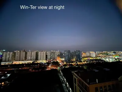 a view of a city at night with buildings at Win-Ter Staycation 1 in Manila