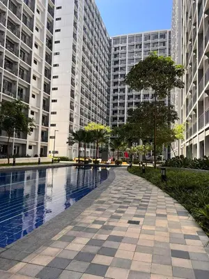 a swimming pool in a city with tall buildings at Win-Ter Staycation 1 in Manila