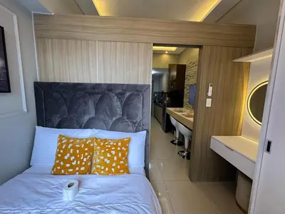 a bedroom with a bed with a large head board at Home of Mari in Shore 2 Residences Room 10107 near Airport, SM MOA, US Embassy Manila by Prime Stay MOA in Manila