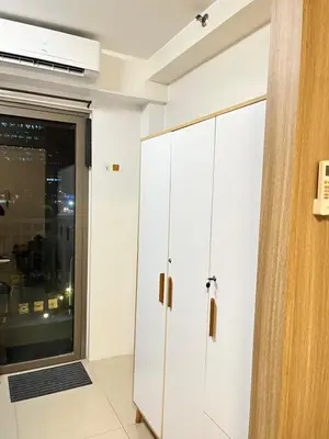 a room with white cabinets and a window at Shore 1 Tower D in Manila