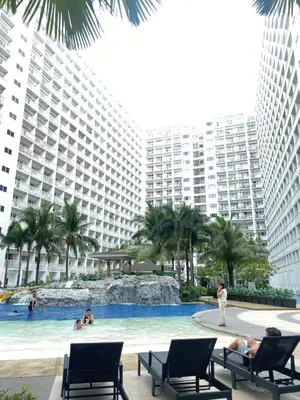 a swimming pool in the middle of a resort at Shore 1 Tower D in Manila