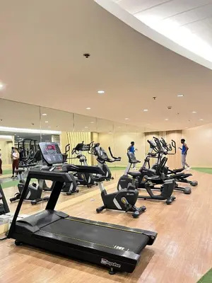 a gym with several treadmills and people in the background at Shore 1 Tower D in Manila