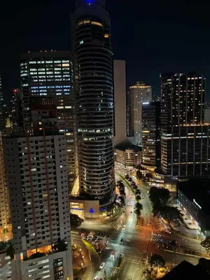 a city lit up at night with buildings at Skyline Blue Air residences 1Br cityview by Tin & Aix in Manila