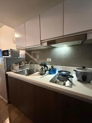 a kitchen with a sink and a stove top oven at Skyline Blue Air residences 1Br cityview by Tin & Aix in Manila